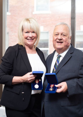 Gail and Phil with their medals.