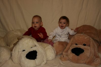 Rhys and Liam White with large toy doys on their first birthday
