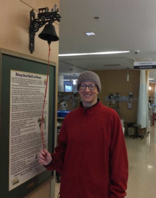 Annette ringing the bell of hope following her final cancer treatment.