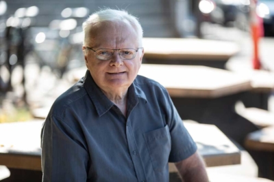 Denis Paquette sitting outside at a table at The Ottawa Hospital.