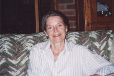 Patricia Whitehead in sitting on a couch in her home.