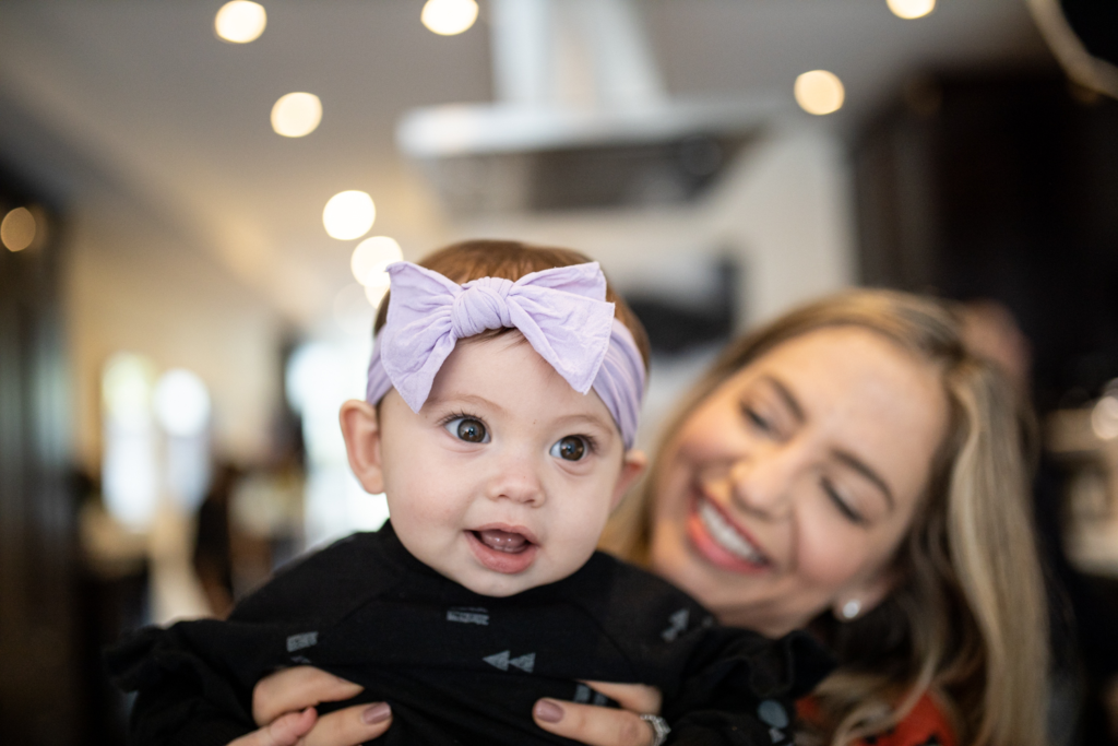 Mom and baby look into camera in kitchen