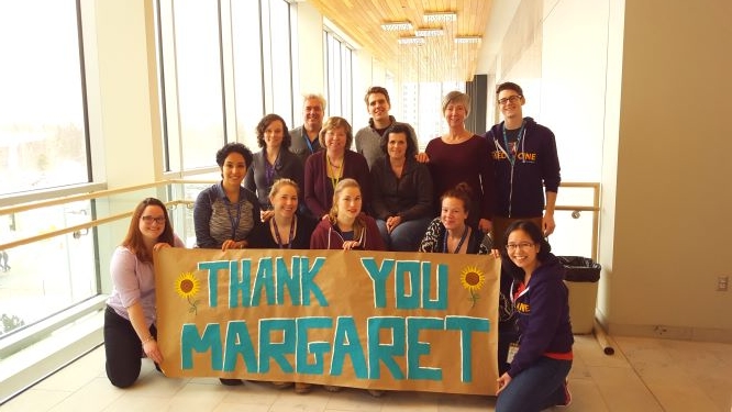 Hospital staff with a banner thanking a patient