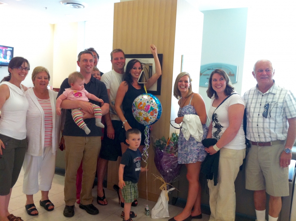 Kim Mountain and her family as she rings the bell.