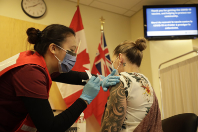 A nurse at The Ottawa Hospital administers the COVID vaccine to a healthcare worker.