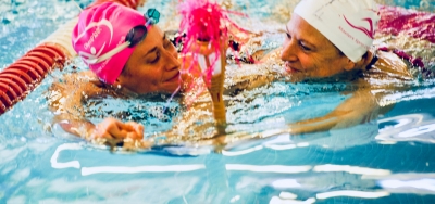 Breast cancer survivor Andrea Douglas swimming with coach Swim coach Andrea Smith.