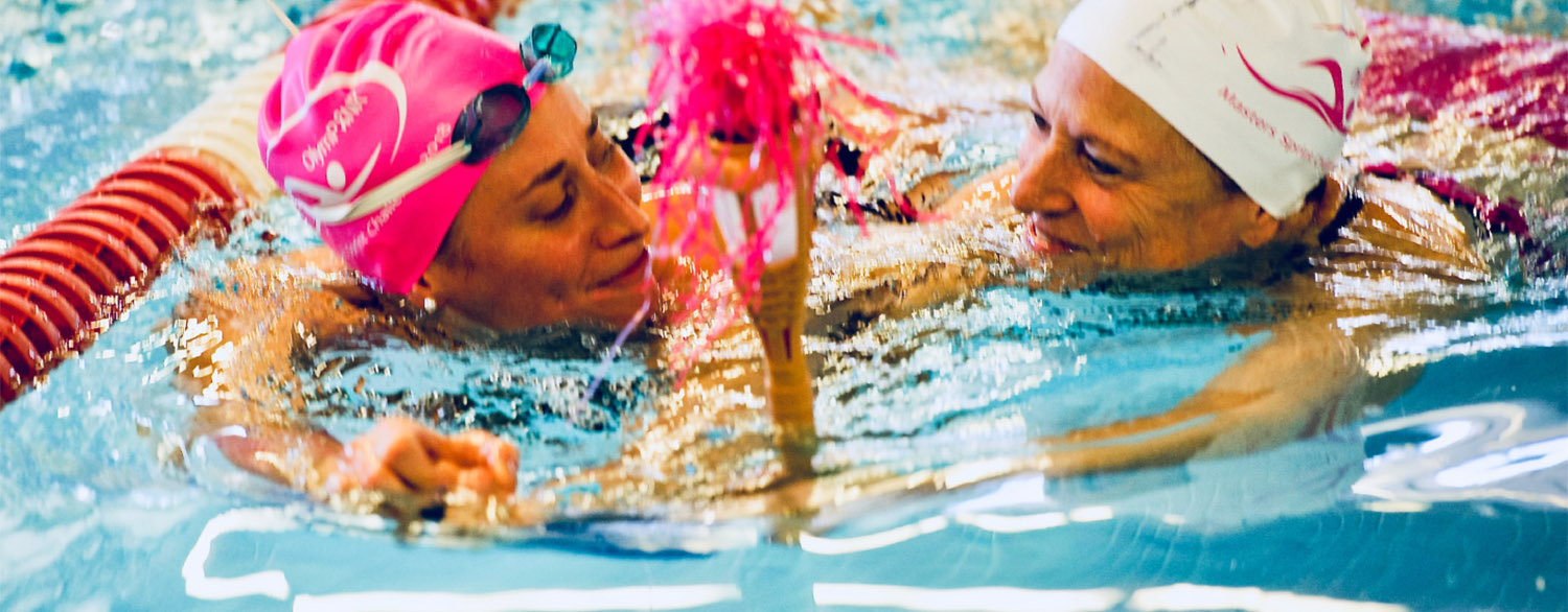 Breast cancer survivor Andrea Douglas swimming with coach Swim coach Andrea Smith.
