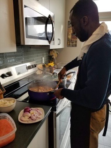 Dr. Meshach Asare-Werehene cooking at home.