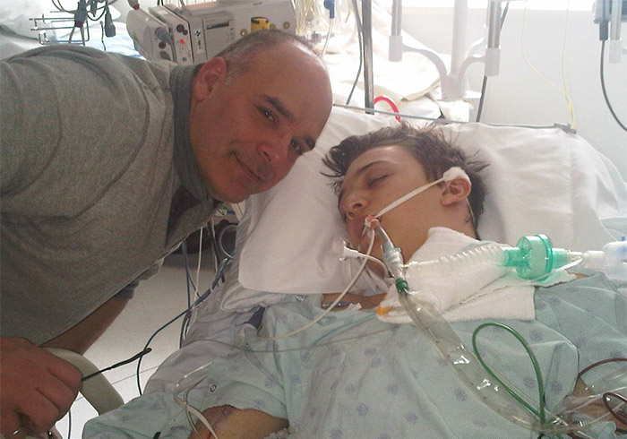 Lukas Marshy, shown with his dad, during treatment at The Ottawa Hospital for a brain hemorrhage.