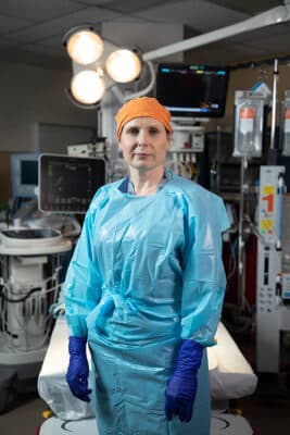 Doctor in scrubs standing in a hospital emergency room