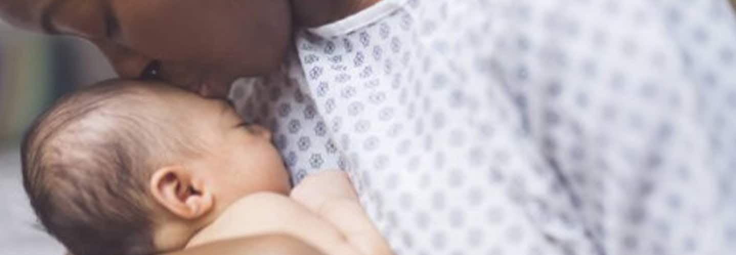woman kissing her babies forehead