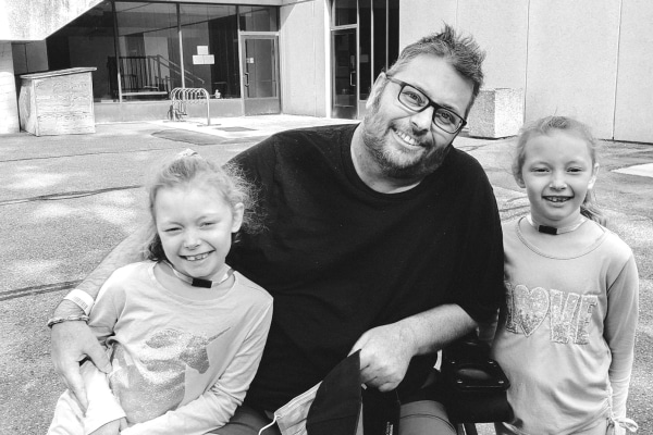 Sean outside the Rehab Centre with his twins