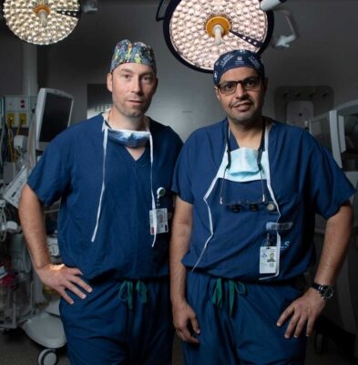 Hospital around the world are lookDr. Fahad AlKherayf and Dr. Shaun Kilty standing in an operating room at The Ottawa Hospital.